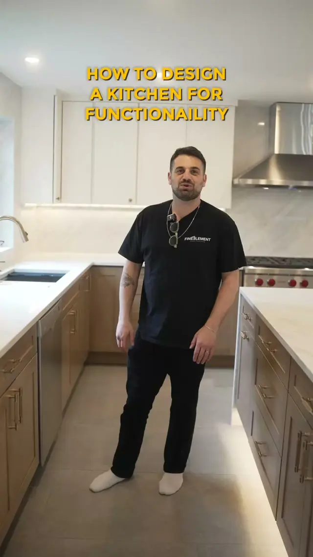 Man in a plain black Fine Element t-shirt and black pants standing in a finished kitchen, with on-screen text reading How to design a kitchen for functionality