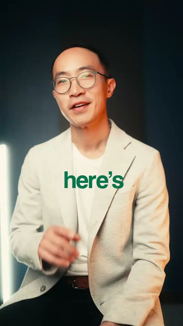 Kevin Lam, a Seattle real estate agent, speaking to camera in a light linen blazer against a dark background in a vertical talking head video