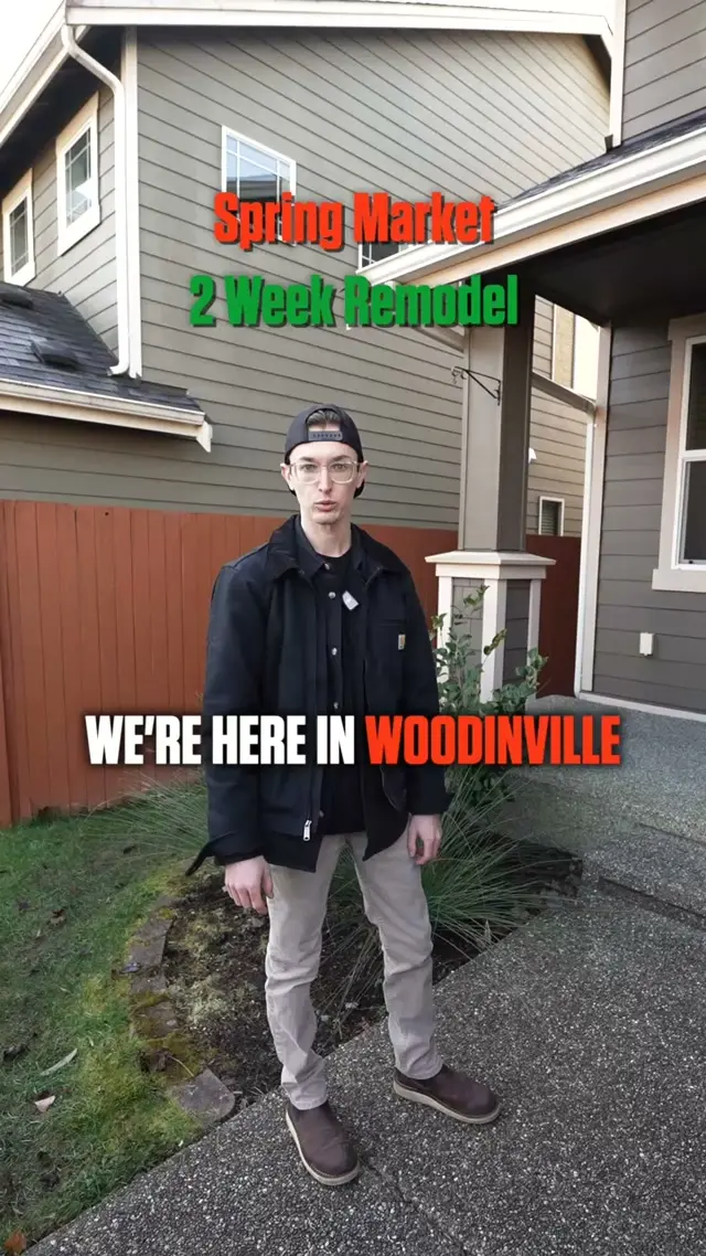 A New Day Construction project manager standing outside a Woodinville house, with on-screen text reading Spring Market 2 Week Remodel and We're here in Woodinville
